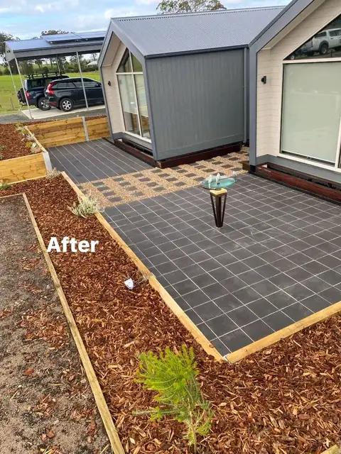 Landscaped yard with timber retaining walls, merbau deck and charcoal paving