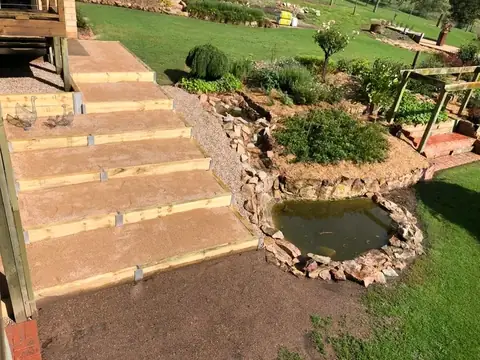 Pond, pergola and lit timber steps in a landscaped garden (6 of 8)